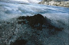 Fine rock dust collects in mounds on the blue ice. 