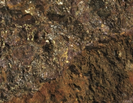 The ore, which can be found above the mine buildings, is rusty on the outside.